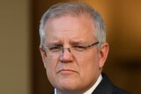 Scott Morrison stands in a marble courtyard