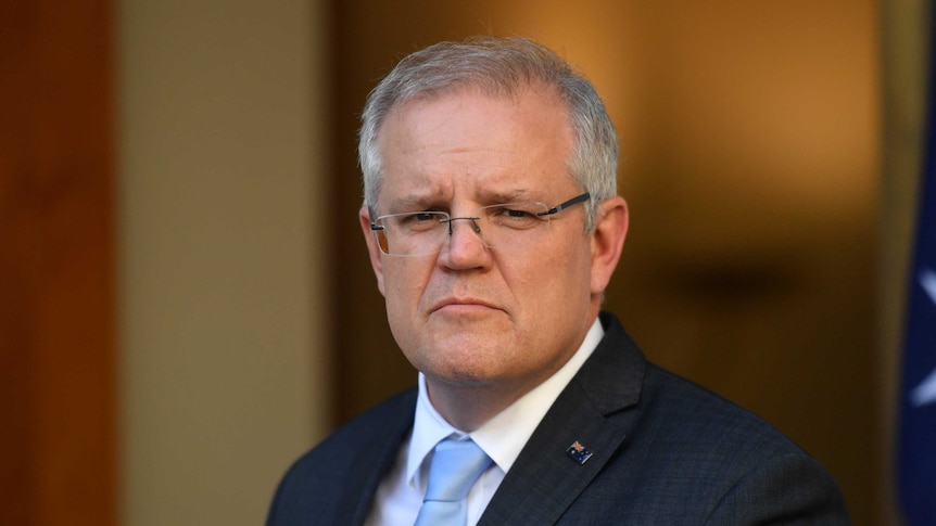 Scott Morrison stands in a marble courtyard