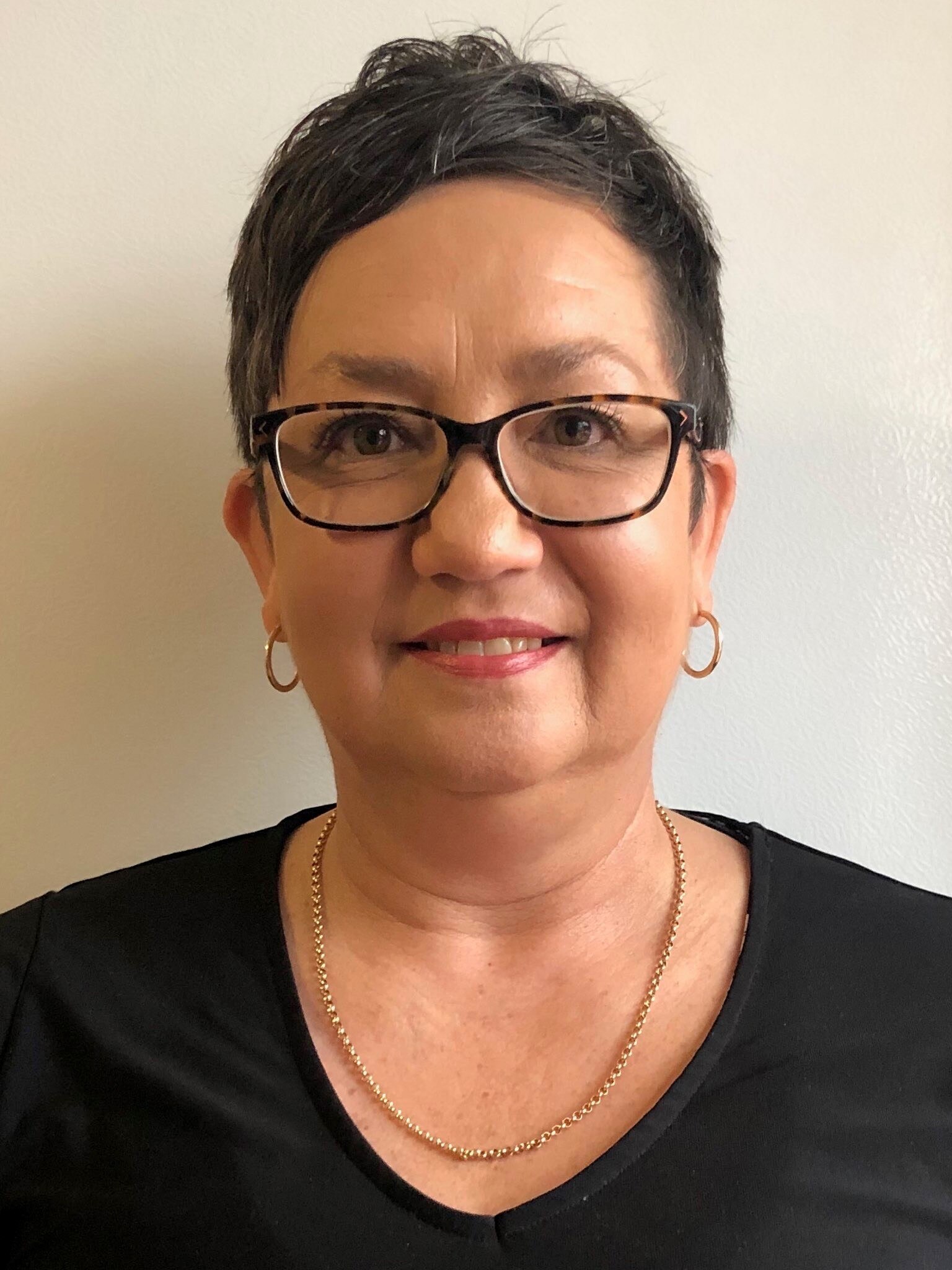 Headshot of Marlene. She has short brown hair and glasses.