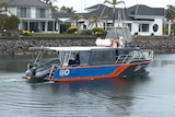 A blue and orange boat in the water.