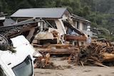 Mud, debris and an upturned truck are seen in a flood-hit area.