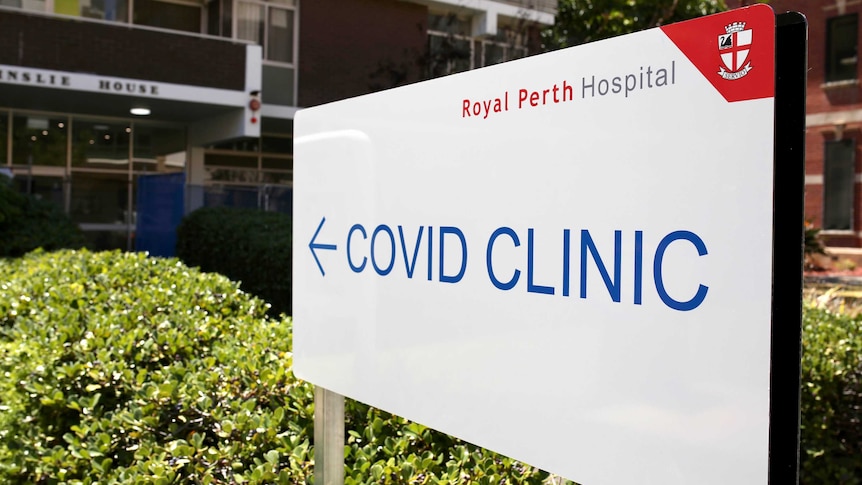 A large white sign says "COVID Clinic" and has the Royal Perth Hospital logo on it.