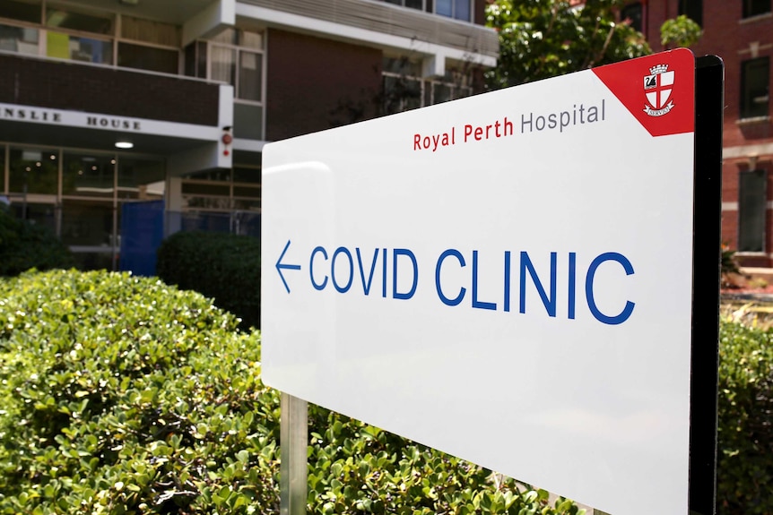 A large white sign says "COVID Clinic" and has the Royal Perth Hospital logo on it.