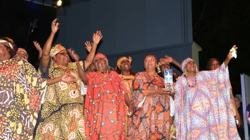 The Central Australian Aboriginal Women's Choir holding an award at the NIMAs.