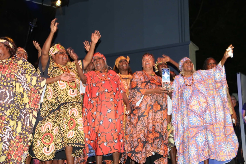 The Central Australian Aboriginal Women's Choir holding an award at the NIMAs.