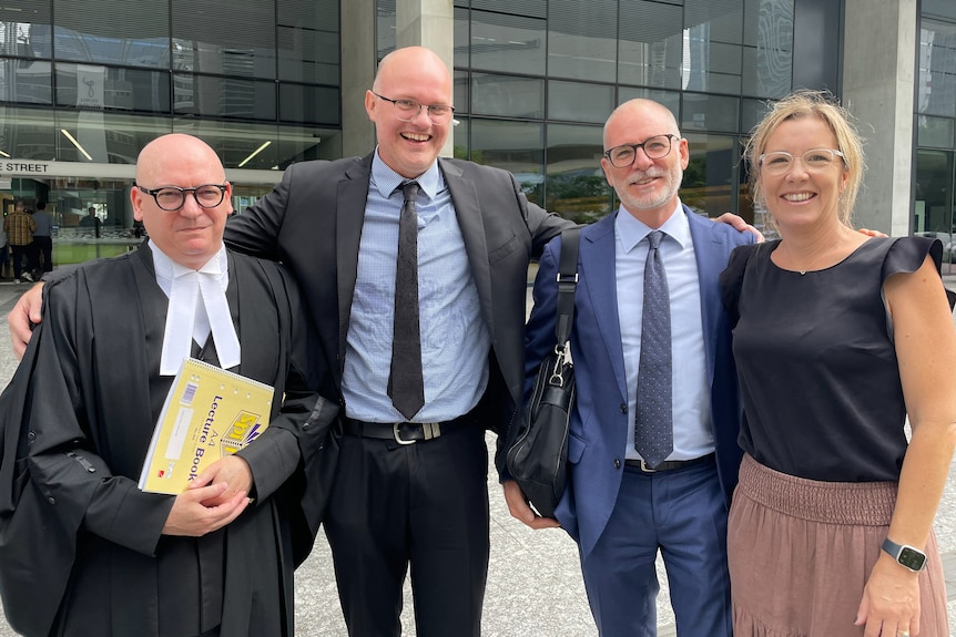 a group of people stand outside court