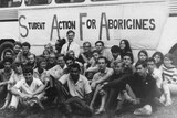 The freedom riders sit in a group in front of their bus in 1965