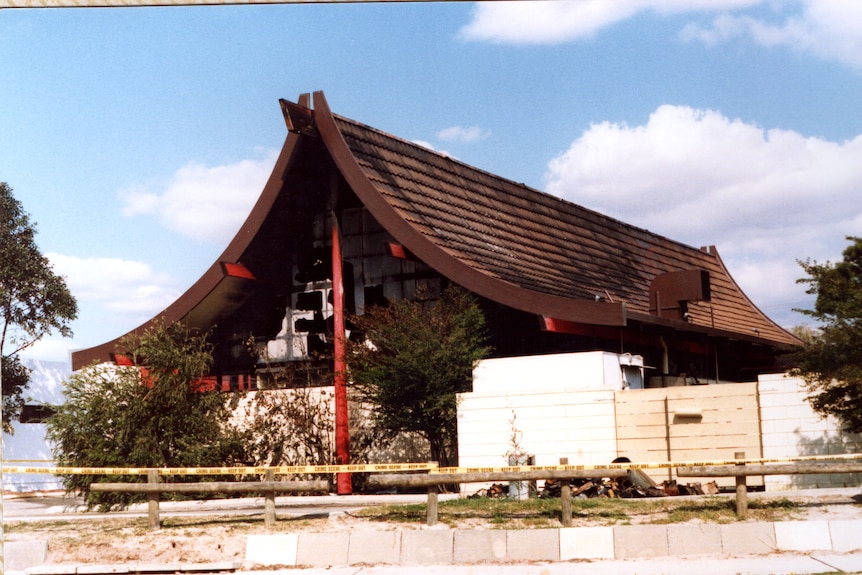 The exterior of a Chinese restaurant with burn marks on the tiled roof.