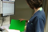 nurse with medical records folder