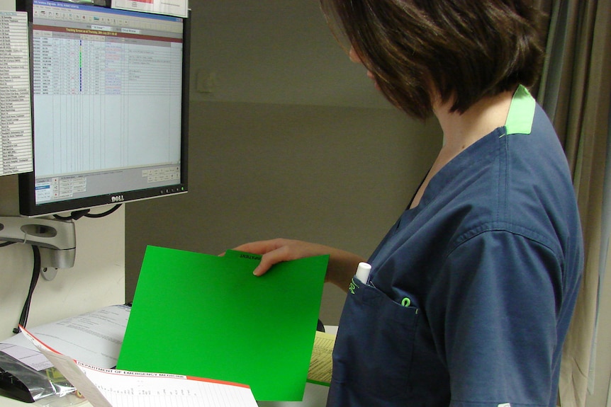 A nurse inspects medical records in the Royal Hobart Hospital's emergency department.