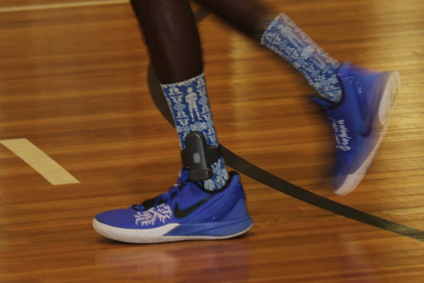 A basketball player wears an ankle tracker as part of the conditions of his bail supported accommodation