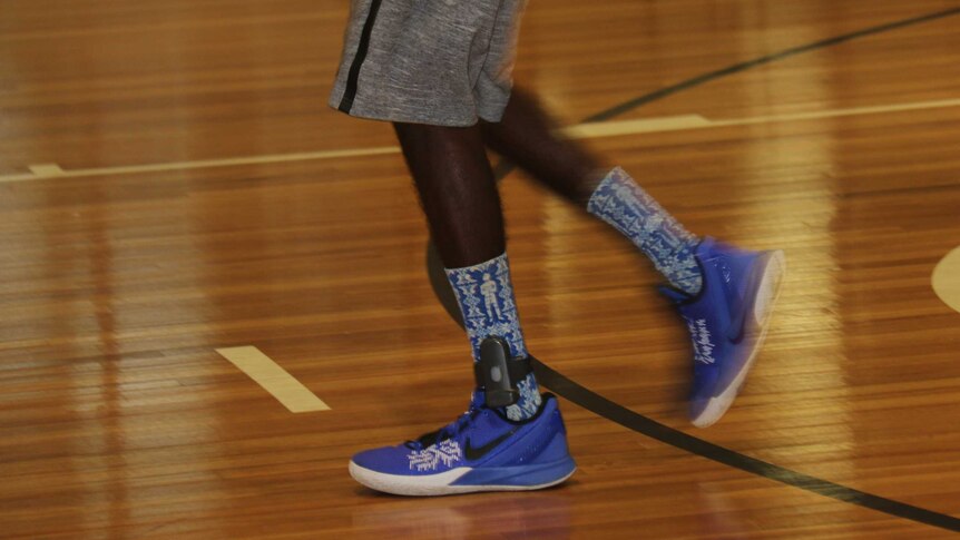 A basketball player wears an ankle tracker as part of the conditions of his bail supported accommodation