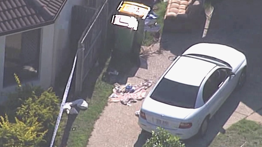 Police tape around a house where police shot a teenage boy