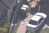 Police tape around a house where police shot a teenage boy