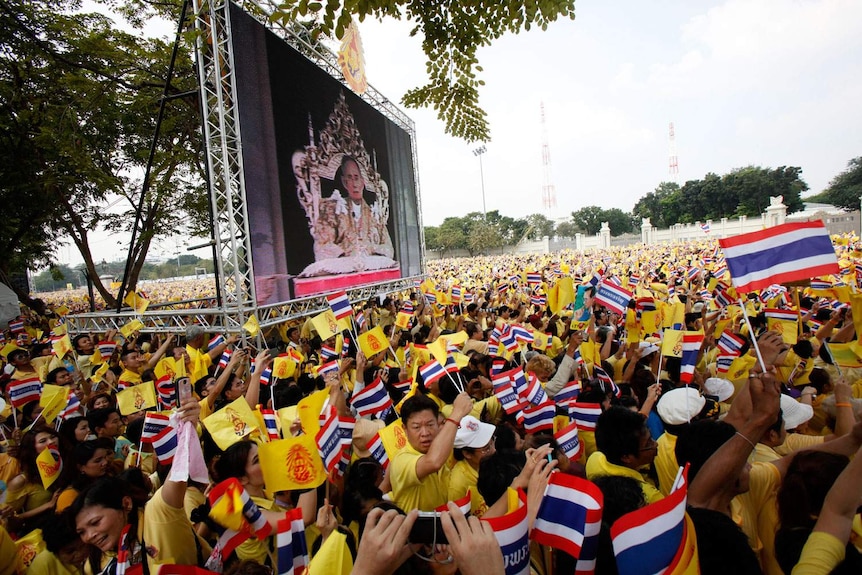 Thais gather during King Bhumibol Adulyadej's birthday speech