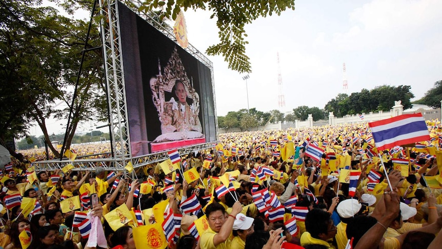 Thais gather during King Bhumibol Adulyadej's birthday speech