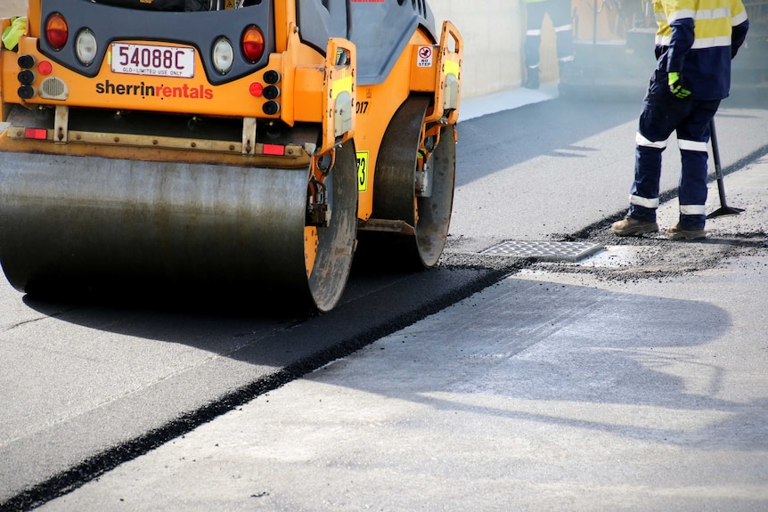 A steam roller paves a new road