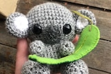 A small grey crocheted koala.