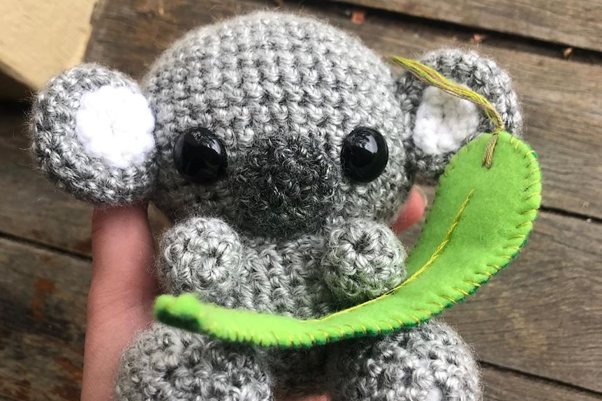 A small grey crocheted koala.