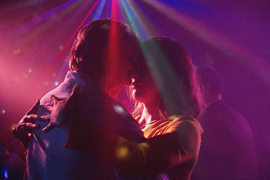 Colour still image from 2018 film A Fantastic Woman of main characters and lovers Marina and Orlando slow dancing.
