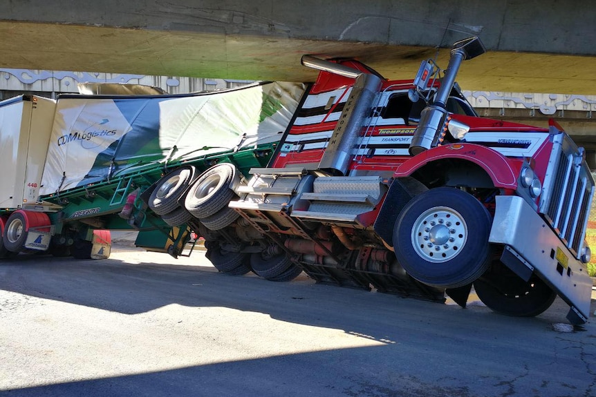 A truck under a bridge.