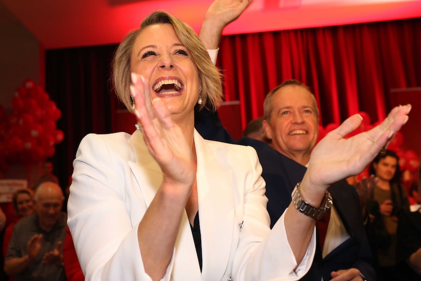 Labor candidate for the federal seat of Bennelong, Kristina Keneally smiling and clapping with Bill Shorten in the background