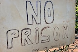 A poster protesting against a proposed prison 
