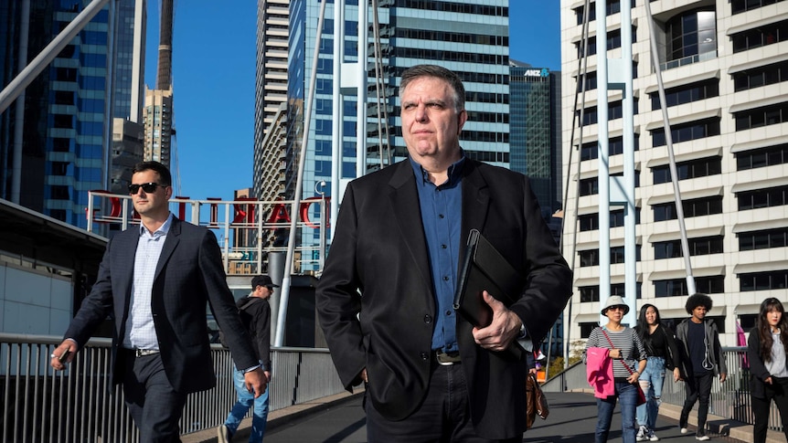 Mortgage Choice franchisee Aurelio Tenaglia standing on a bridge with the Sydney CBD in the background