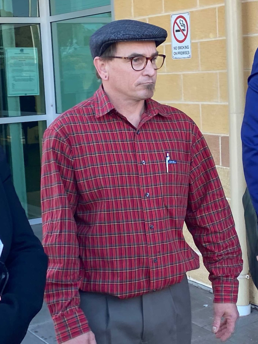 A man in a red chequered shirt.