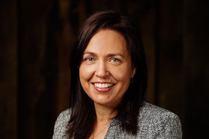 Dark haired woman in suit