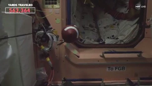 Astronauts at the International Space Station throw football in space