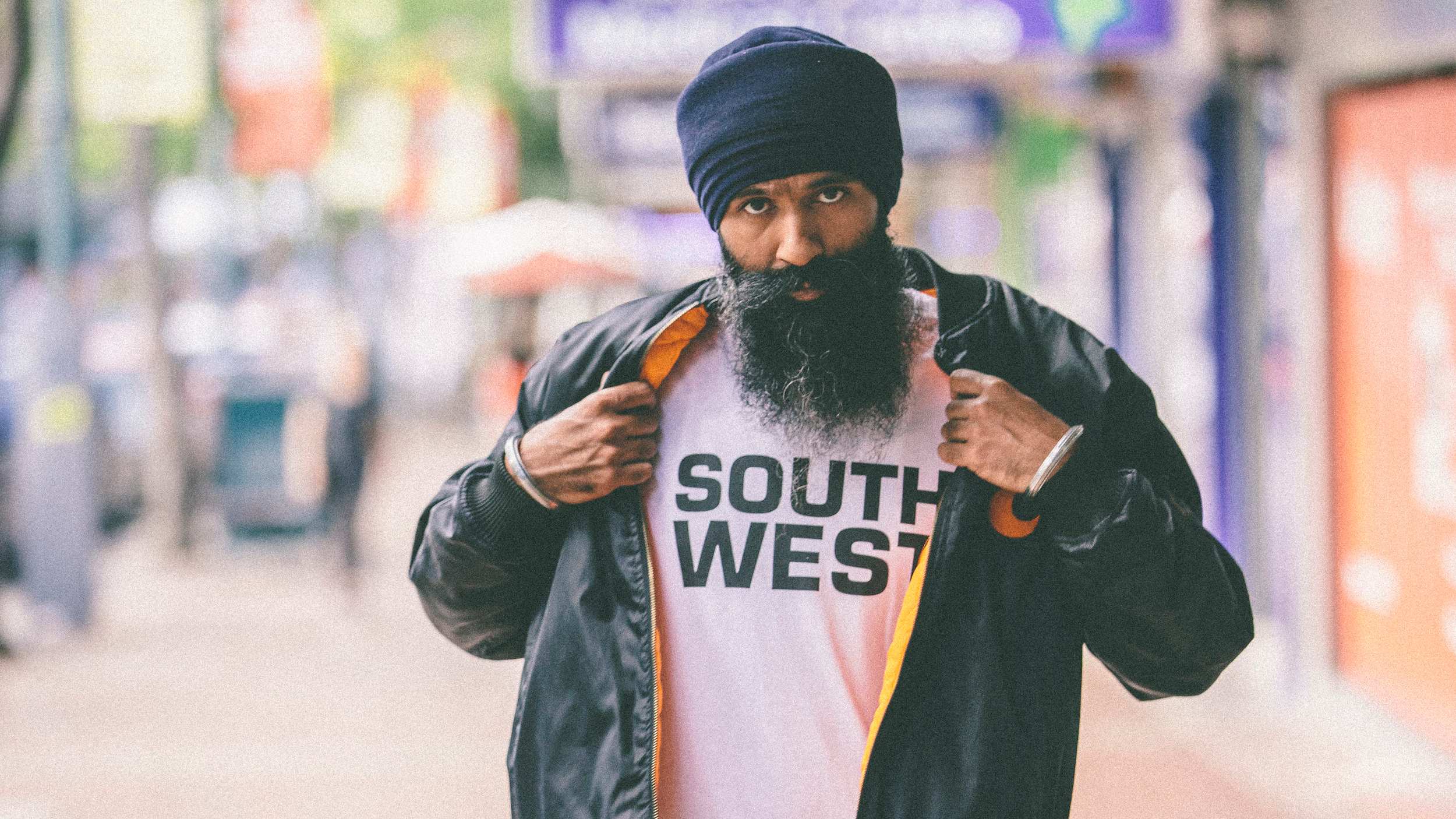 Sydney hip-hop artist Sukhdeep Singh Bhogal AKA L-Fresh the Lion wearing a t-shirt saying "South West"