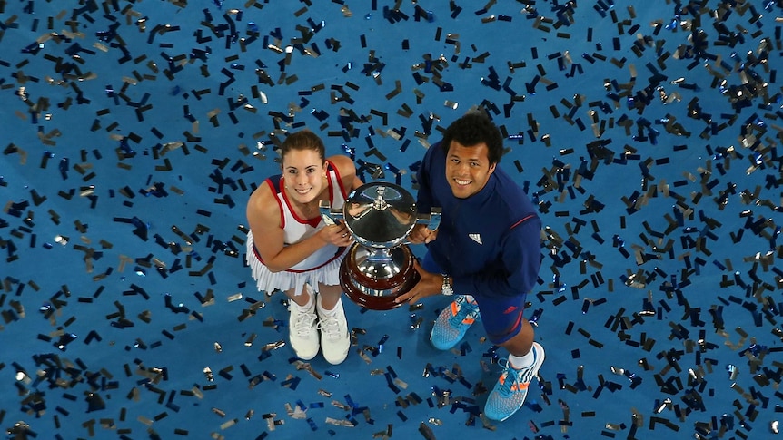 France's Alize Cornet and Jo-Wilfried Tsonga pose with the Hopman Cup trophy after beating Poland.