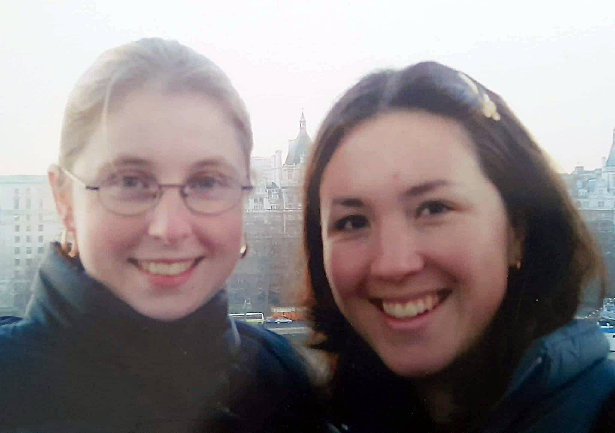 Two young women smiling to camera.