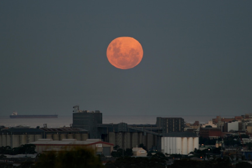 The 'supermoon' rises over Newcastle.
