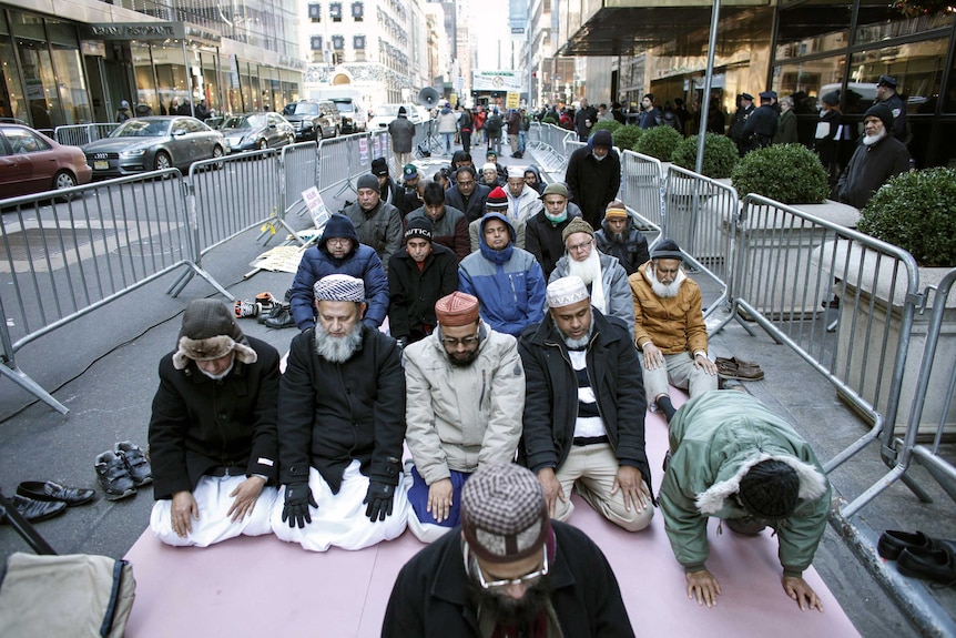 Muslims kneel in prayer on the street outside Trump Tower in New York City.