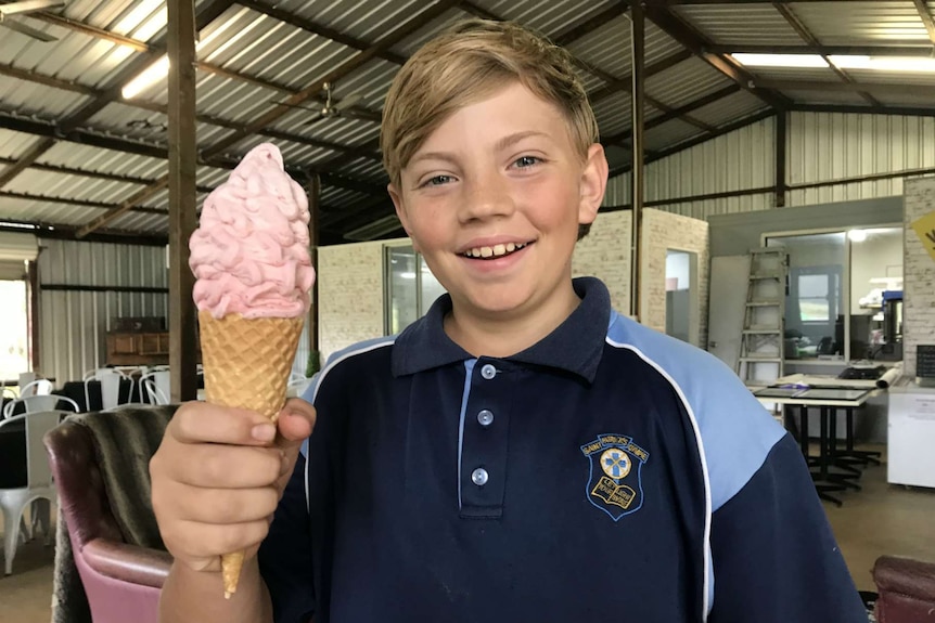 Patrick Lewis holding a strawberry icecream