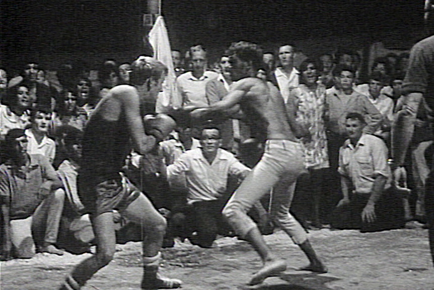 A fight in a boxing tent show.