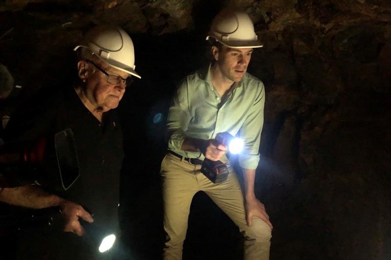 Photo of two men with torches.