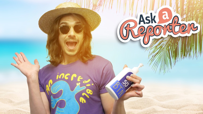 Jack smiles wearing a hat and sunglasses and holding a bottle of sunscreen.