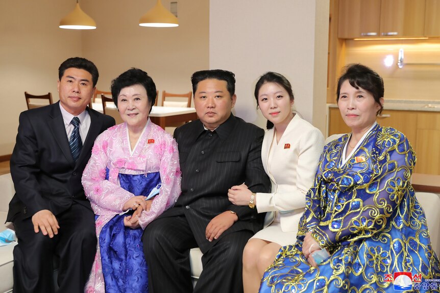 North Korean leader Kim Jong Un poses with North Korean announcer Ri Chun-hee and her family.