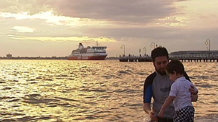 Father and son frolic in Port Phillip Bay