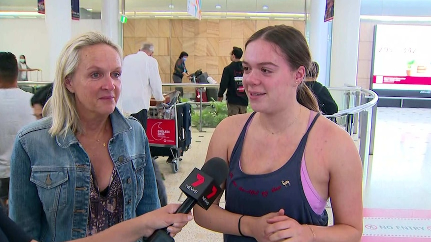 Two woman talk to a reporter