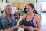 Two woman talk to a reporter