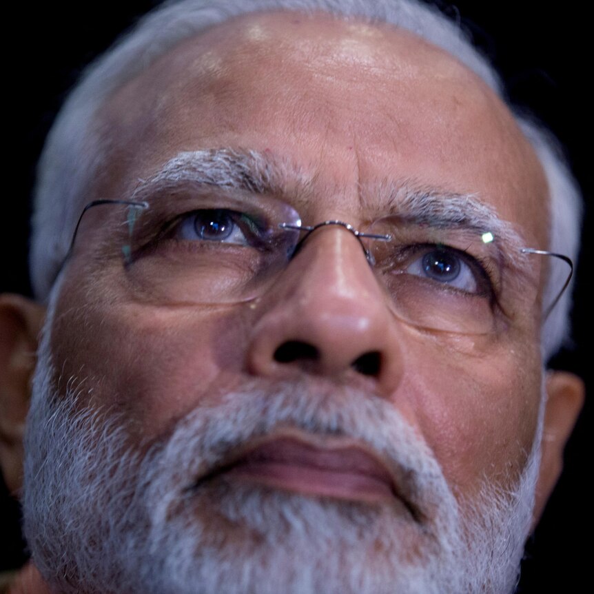 A close up of Narendra Modi's face.