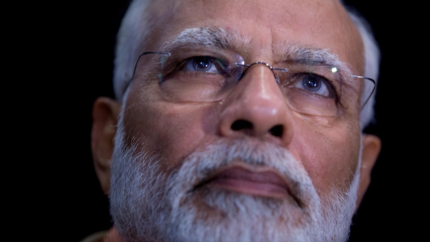 A close up of Narendra Modi's face.