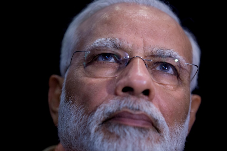 A close up of Narendra Modi's face.