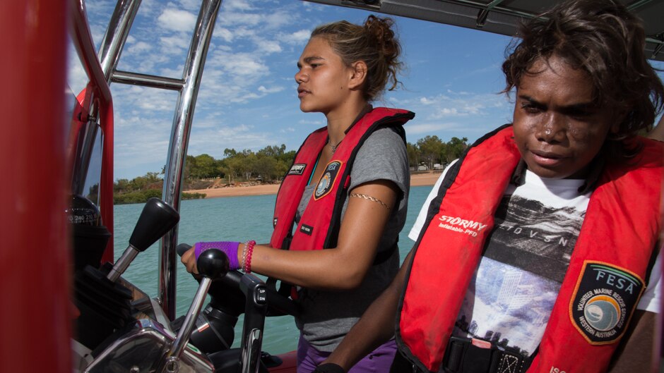 Jemima Wilson takes the wheel of the Broome sea rescue boat with Lily Mandijarra.