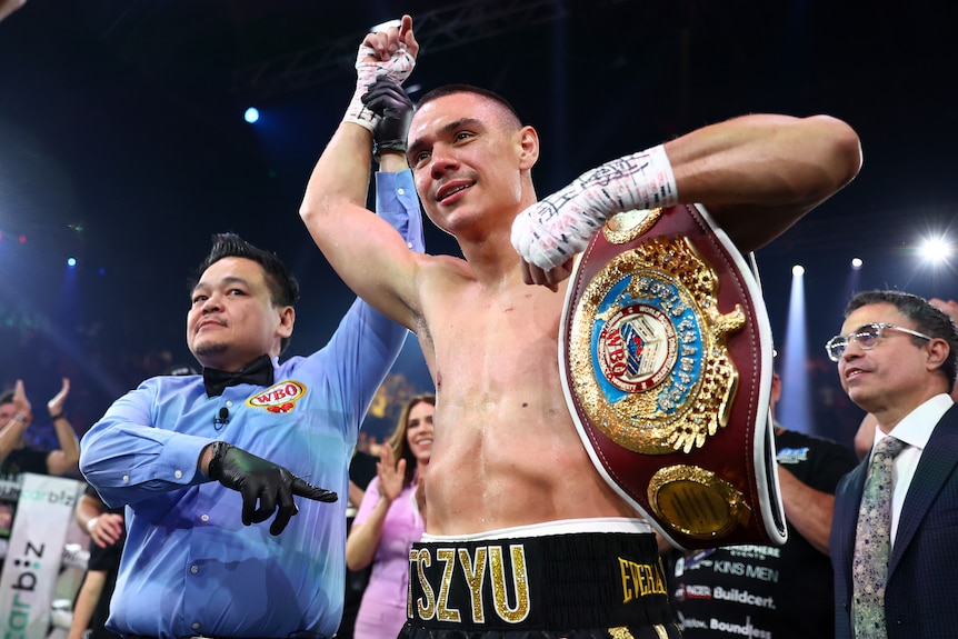 Tim Tszyu has his hand raised with a belt across his shoulder