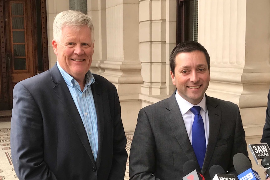 John Schurink with Matthew Guy speak to the media outside Parliament in Victoria.